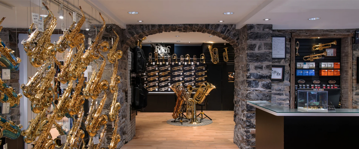 Twigg Music store interior — stone archways displaying saxophones and brass instruments
