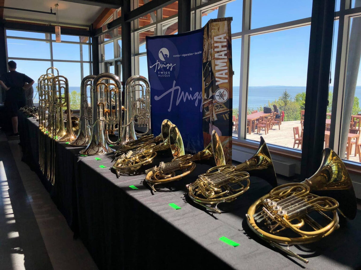 Brass instruments on display at a Twigg Music showcase overlooking water